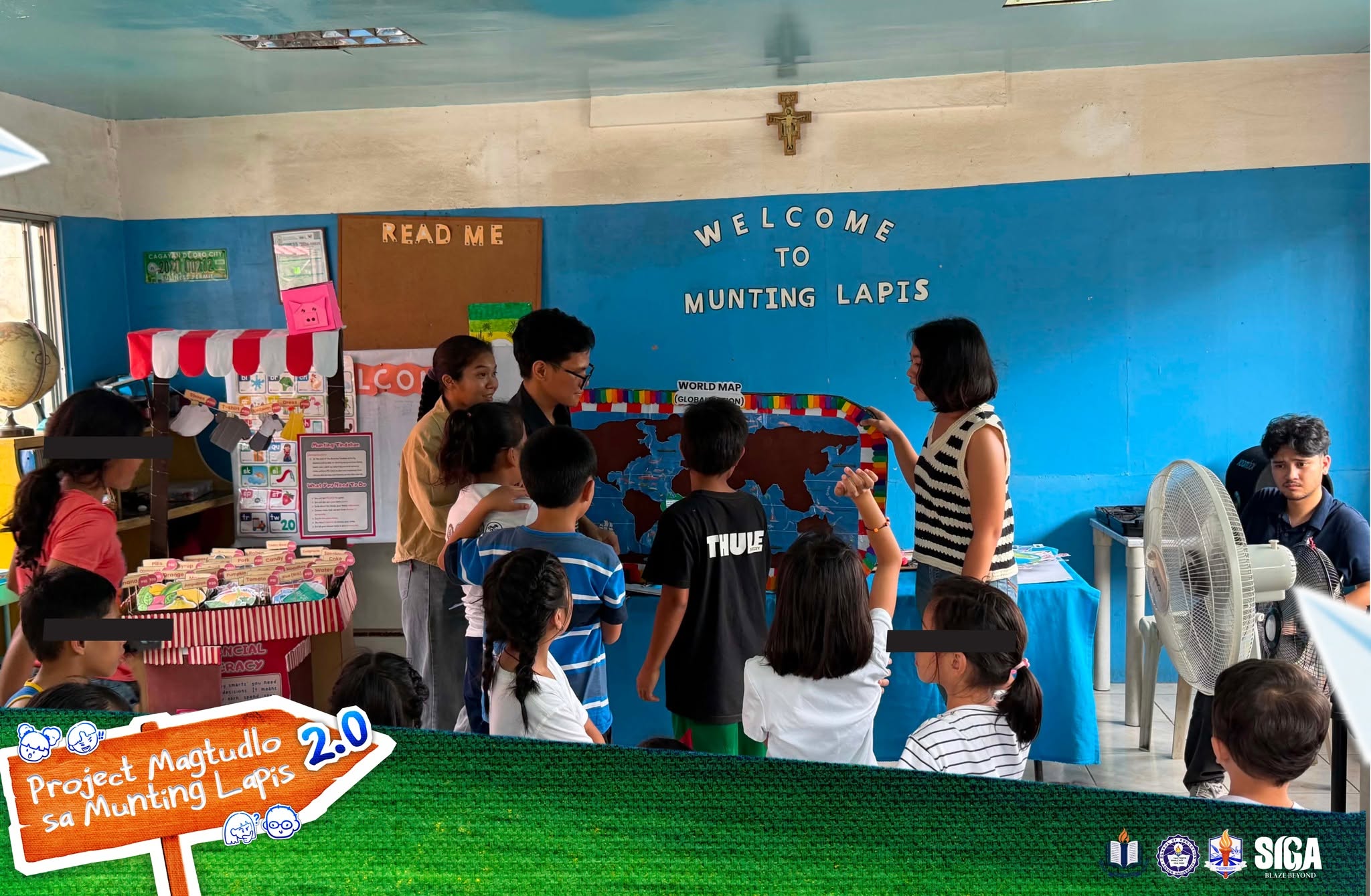 Children and volunteers meet around classroom tables