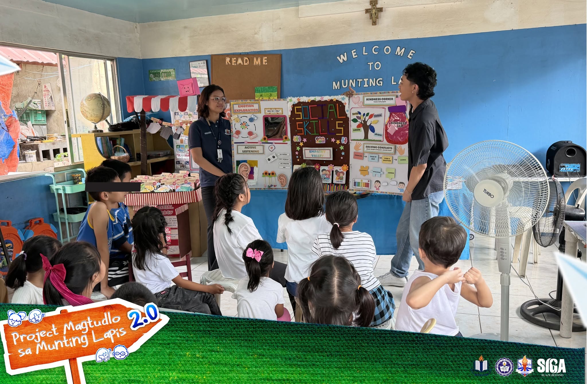 A volunteer leads a lesson for seated children